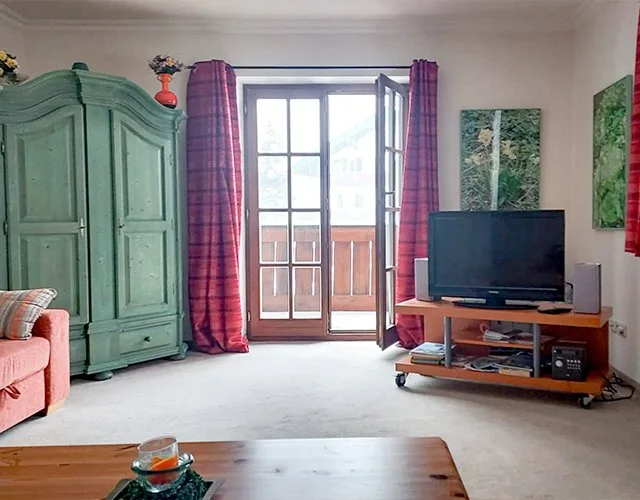 Living room inside the apartment with seating and soft natural light.
