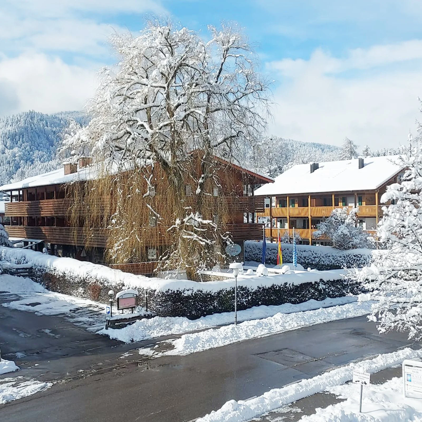 Snowy exterior view of the Haus Adrian building in winter.
