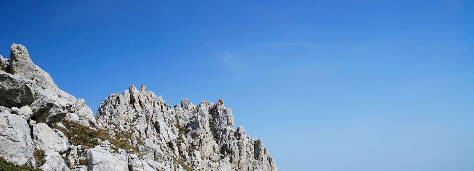 Rocky mountain ridge under a clear blue sky.